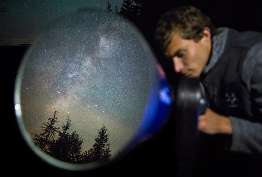 Student looking at telescope